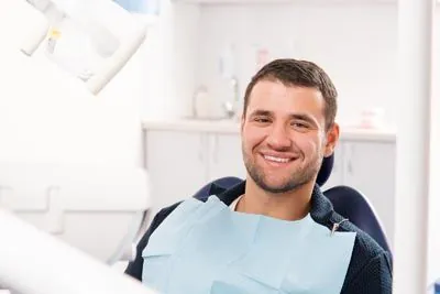 man smiling during his oral surgery appointment at Acre Wood Dental - Gatesville