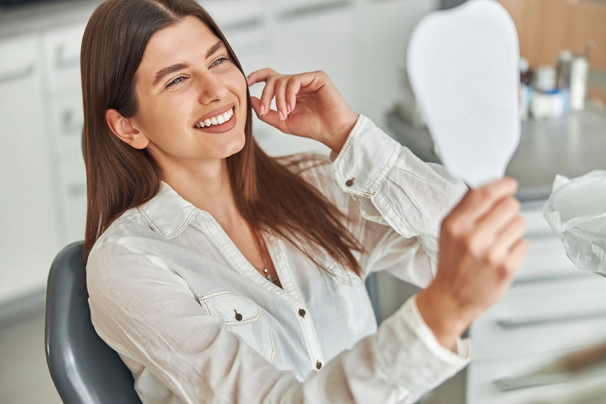 woman loving her smile thanks to Acre Wood Dental - Temple
