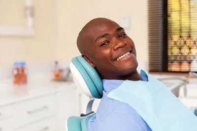 man laying back in the dental chair at Acre Wood Dental - Temple