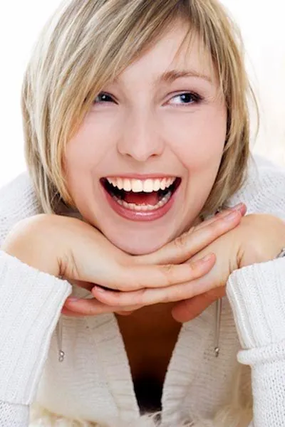 woman showing a freshly cleaned smile thanks to periodontal therapy from Acre Wood Dental - Temple