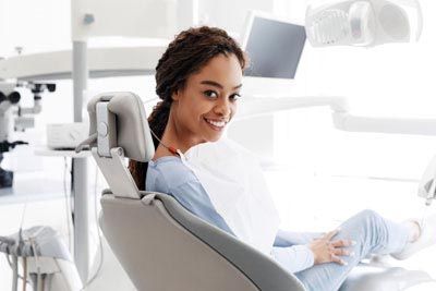 woman smiling during her restorative appointment at Acre Wood Dental - Temple