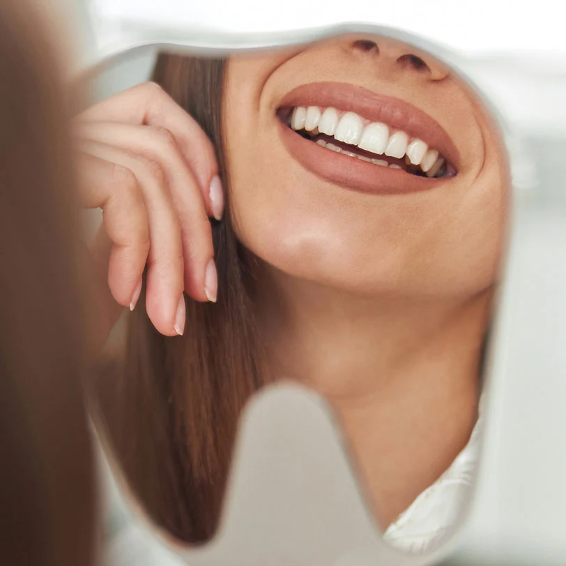 woman loving her smile after visiting Acre Wood Dental in Waco, TX