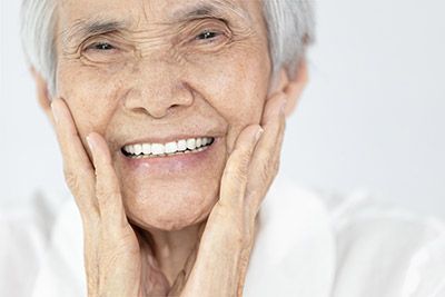 woman smiling after getting dental implants in Waco, TX