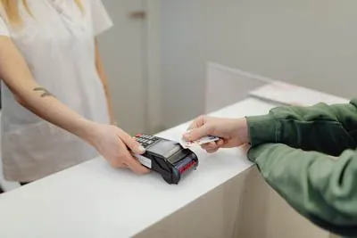 patient paying for their dental appointment at Acre Wood Dental - Waco