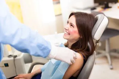 woman smiling during her visit to Acre Wood Dental - Waco