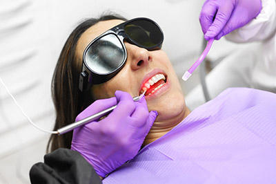 woman receiving laser dentistry procedure at Acre Wood Dental - Waco