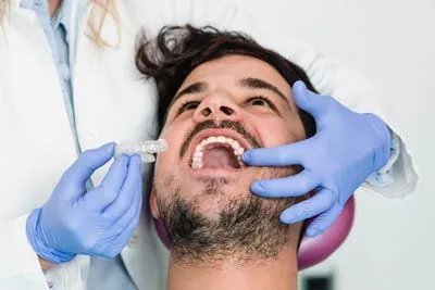 man being fitted for his new clear aligners
