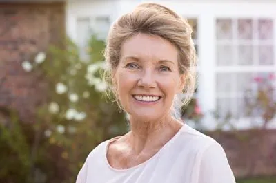 woman with dental implants smiling