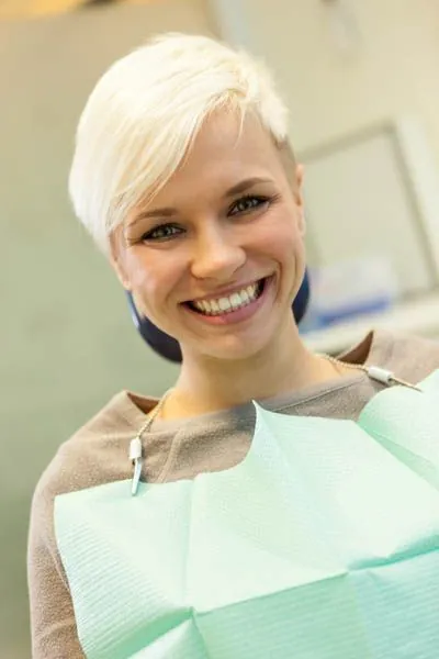 woman showing her new dental veneers from Acre Wood Dental in Waco, TX