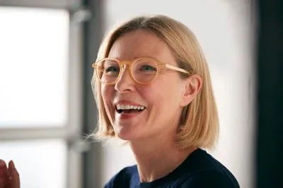 woman showing her same-day dental crowns from Acre Wood Dental - Waco