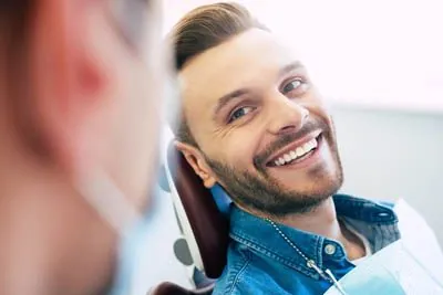man smiling during his dental appointment at Acre Wood Dental - Waco