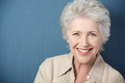 woman smiling big with her new dentures from Acre Wood Dental - Waco